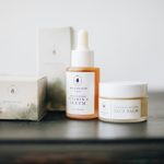 A serene presentation of vitamin C serum and face balm showcasing a minimalist skincare collection.